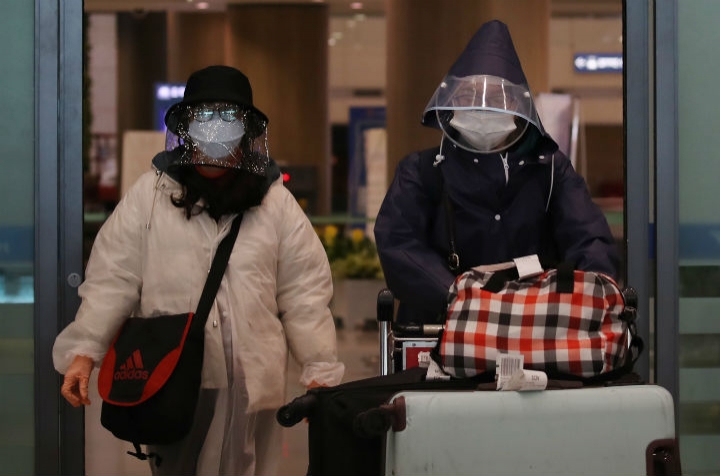 26일 영종도 인천국제공항에서 비닐 모자를 쓴 중국인 관광객들이 입국장을 나서고 있다. [사진=연합뉴스]
