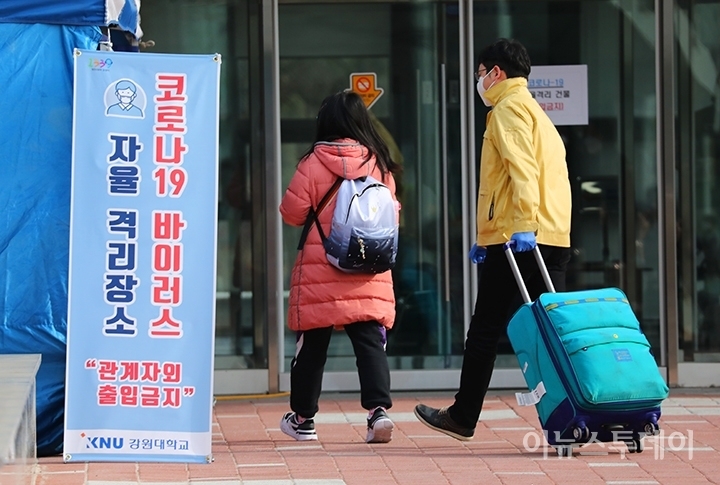 지난달 24일 강원 춘천시 강원대학교 학생기숙사 이룸관에서 인천공항을 통해 입국한 중국 유학생들이 격리장소인 기숙사로 들어가고 있는 모습.