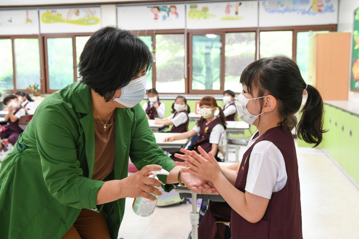 광양제철초등학교 1~2학년 학생들이 마스크를 착용하고 손 소독제를 사용하고 있다.[사진=광양제철소]