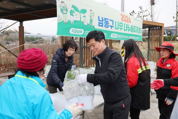 박종효 구청장(오른쪽), 주민들에게 나무를 나눠주고 있다. [사진=남동구]