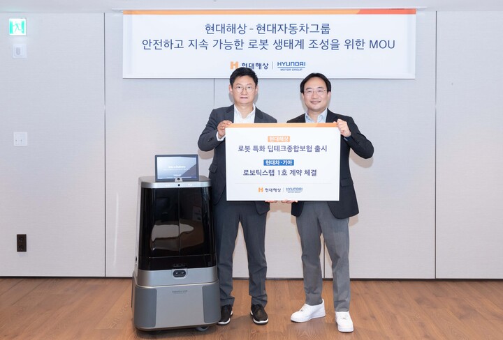 24일 서울시 종로구 현대해상 본사에서 열린 ‘로보틱스 기반 보험 및 금융 서비스 고도화를 위한 업무협약(MOU)’에서 참석자들이 기념사진을 촬영하는 모습. (왼쪽부터) 현대해상 기업보험부문장 윤의영 전무, 현대차·기아 로보틱스랩 현동진 상무. [사진=현대차·기아]